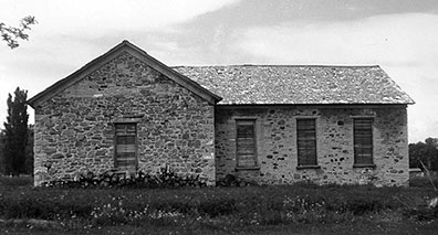 The original 1865 rock church is on the right, with the three windows. The T was added on later.